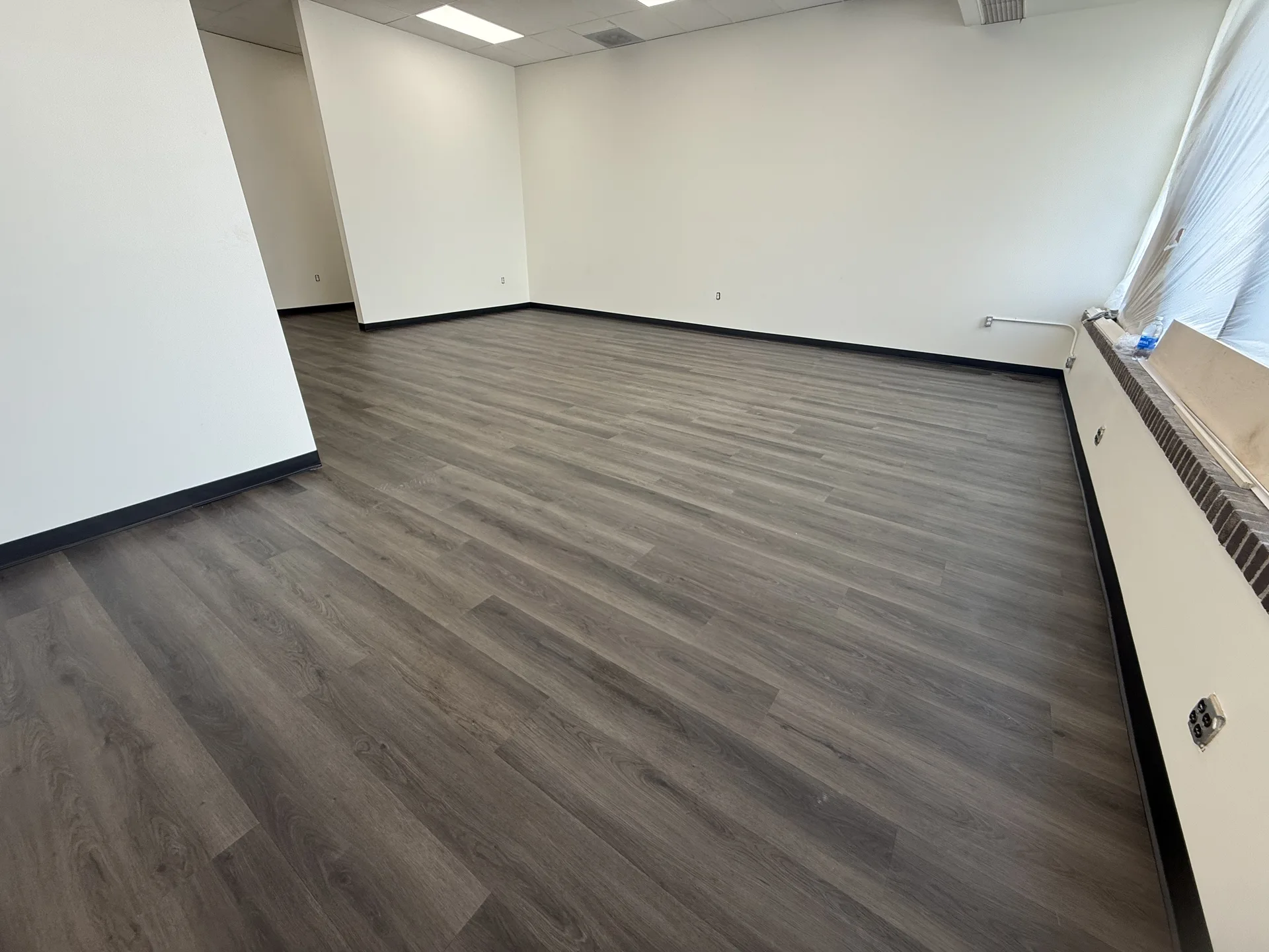 luxury vinyl flooring installed by BRC Flooring — finished basement