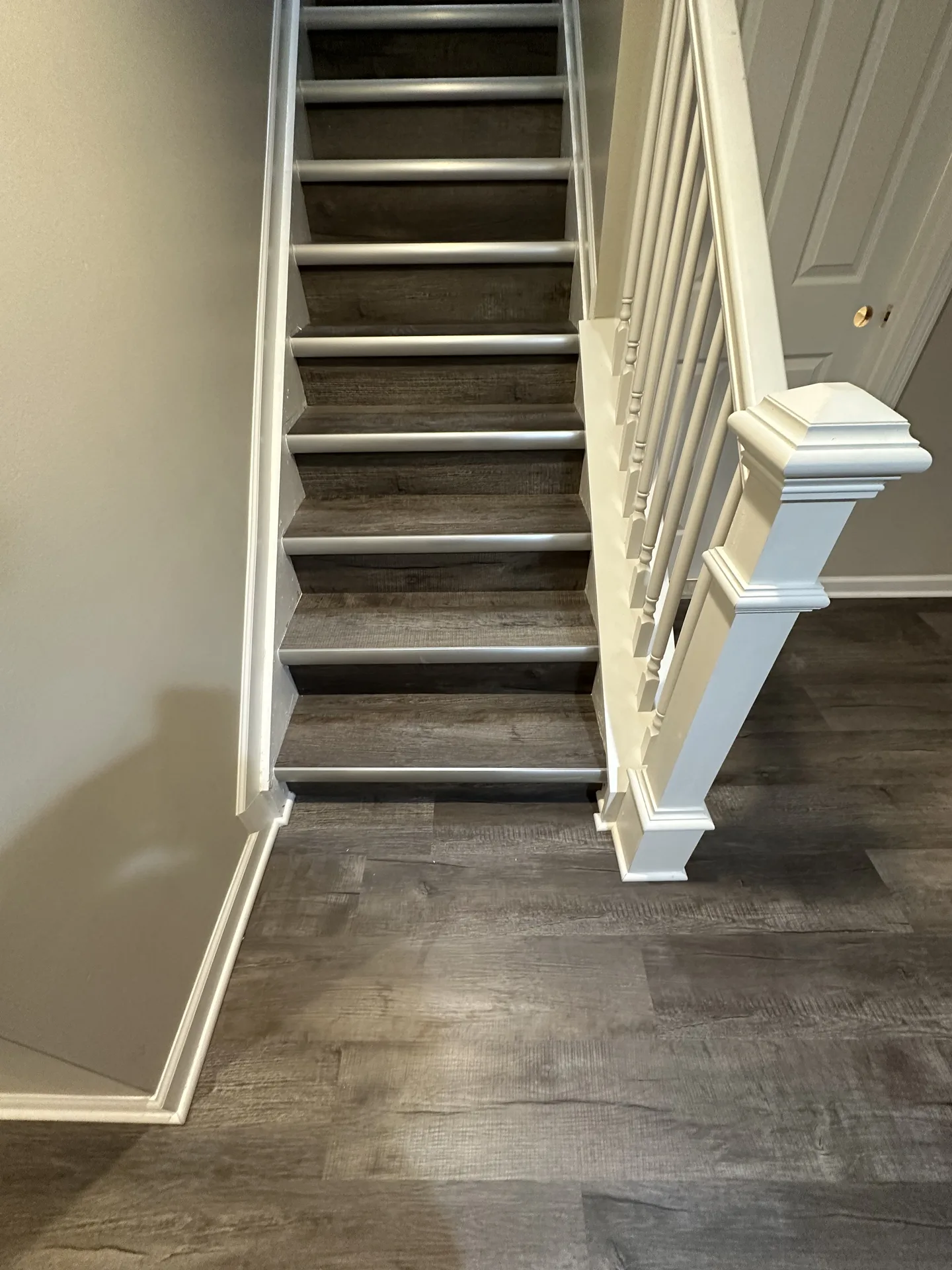 luxury vinyl flooring installed by BRC Flooring — staircase & hallway