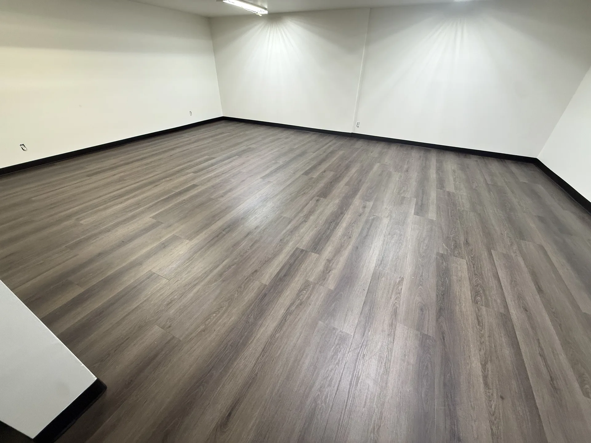 luxury vinyl flooring installed by BRC Flooring — finished basement