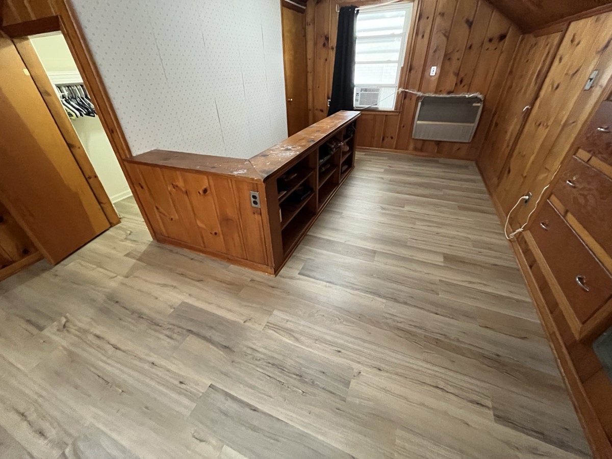 LVP flooring in cabin-style room with knotty pine
