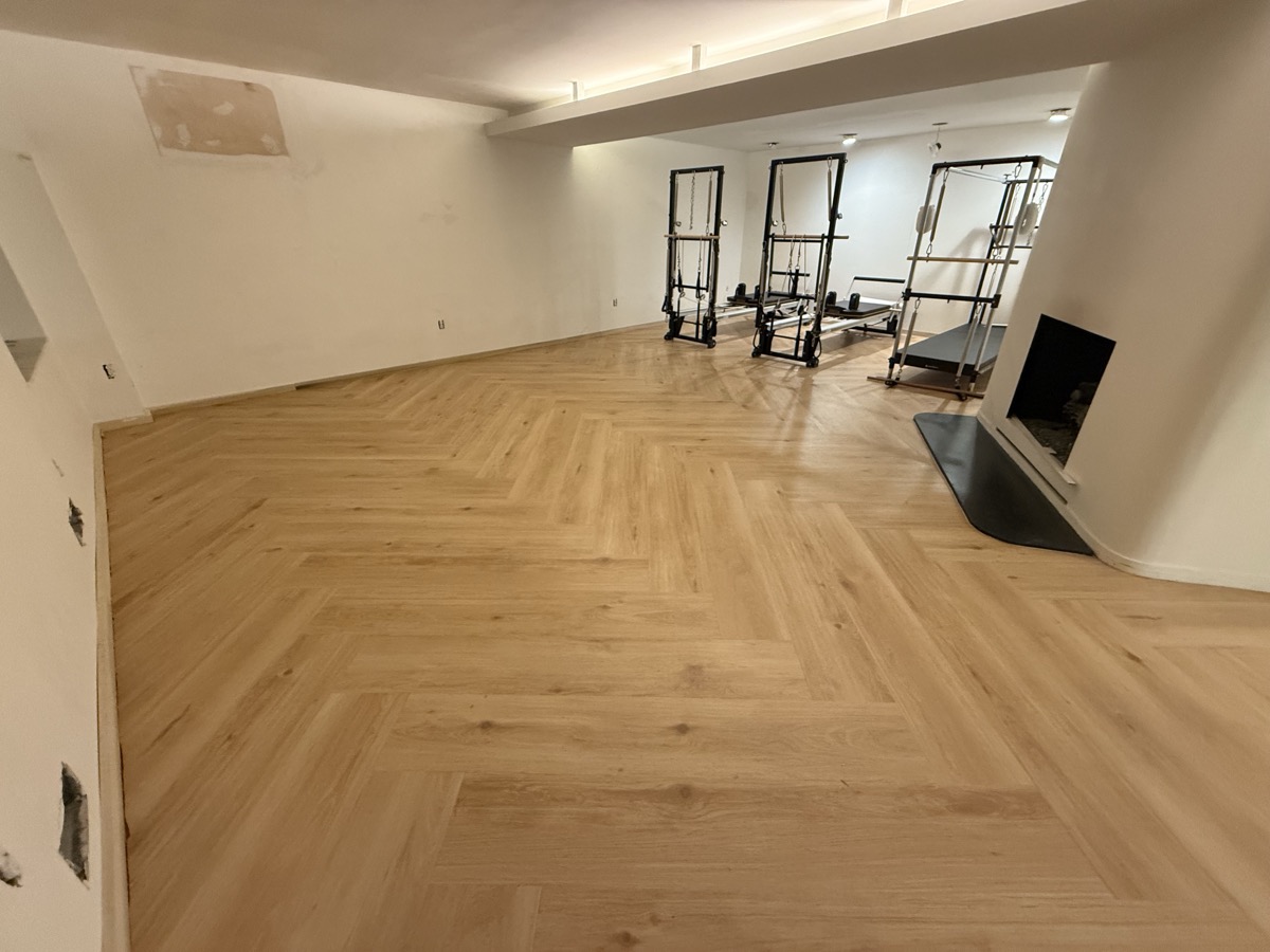 Herringbone hardwood flooring in fitness studio
