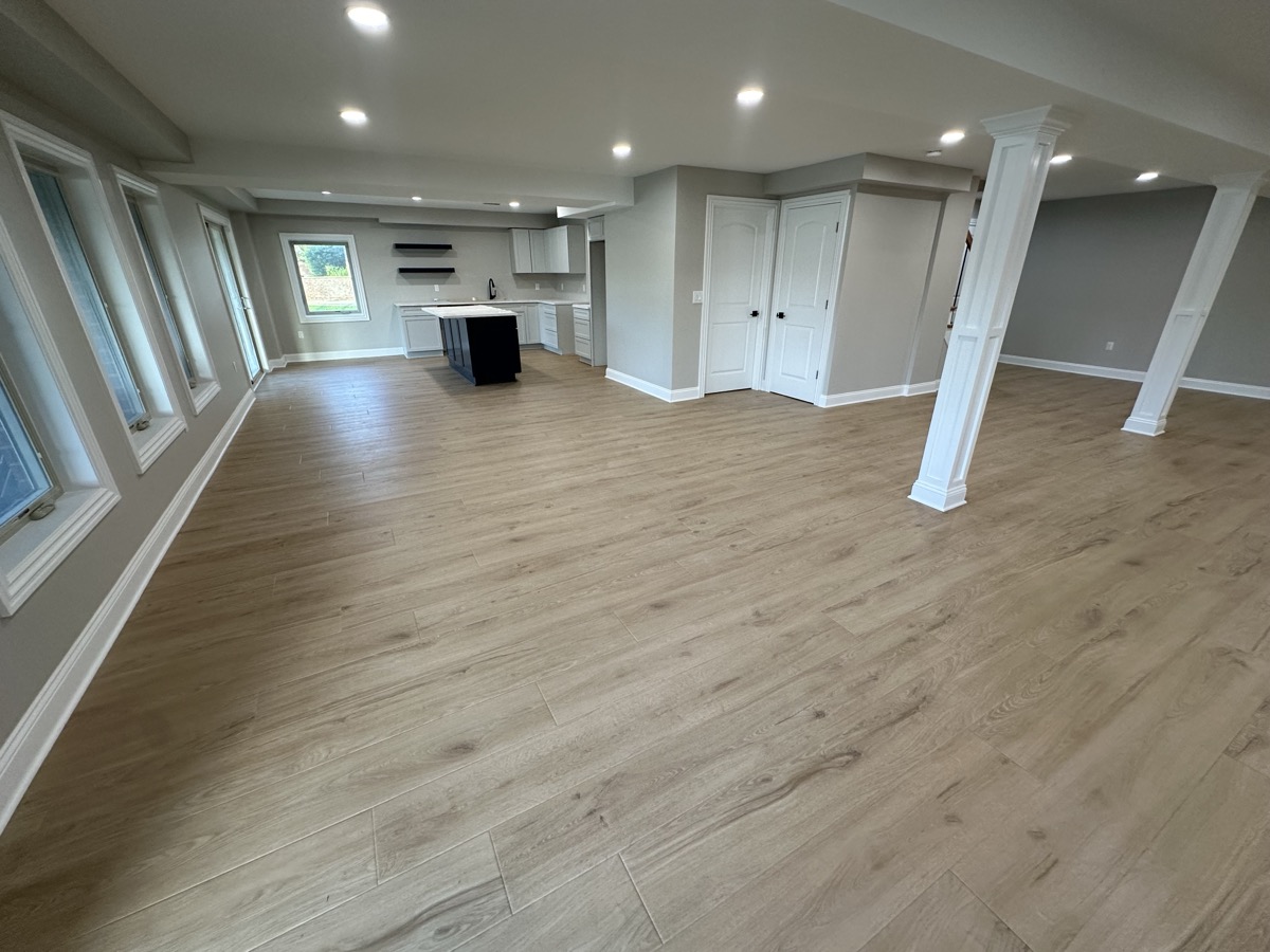 LVP in finished basement with kitchen island