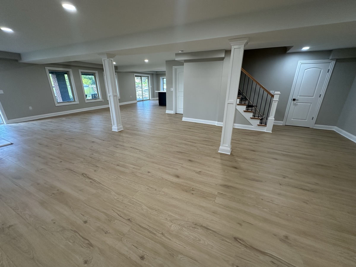 LVP in large finished basement with staircase