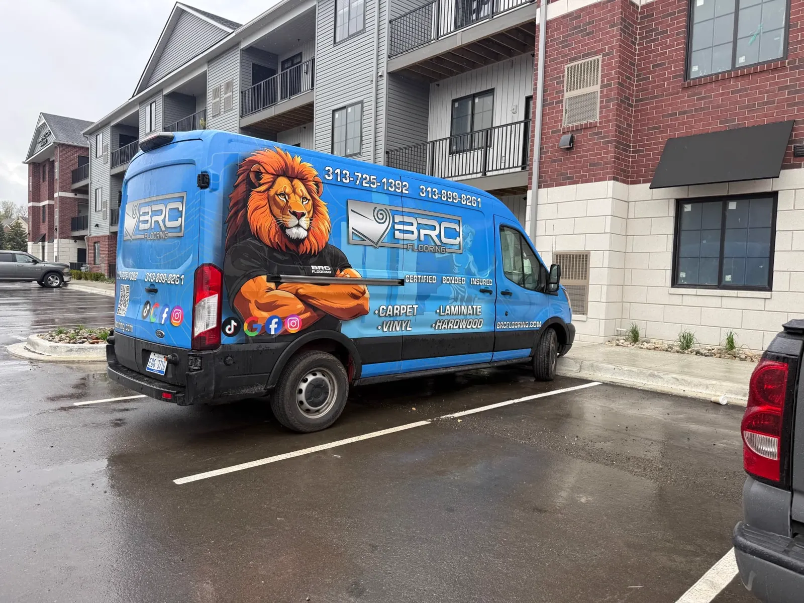 BRC Flooring's wrapped service van with the company lion mascot, ready for a Detroit install