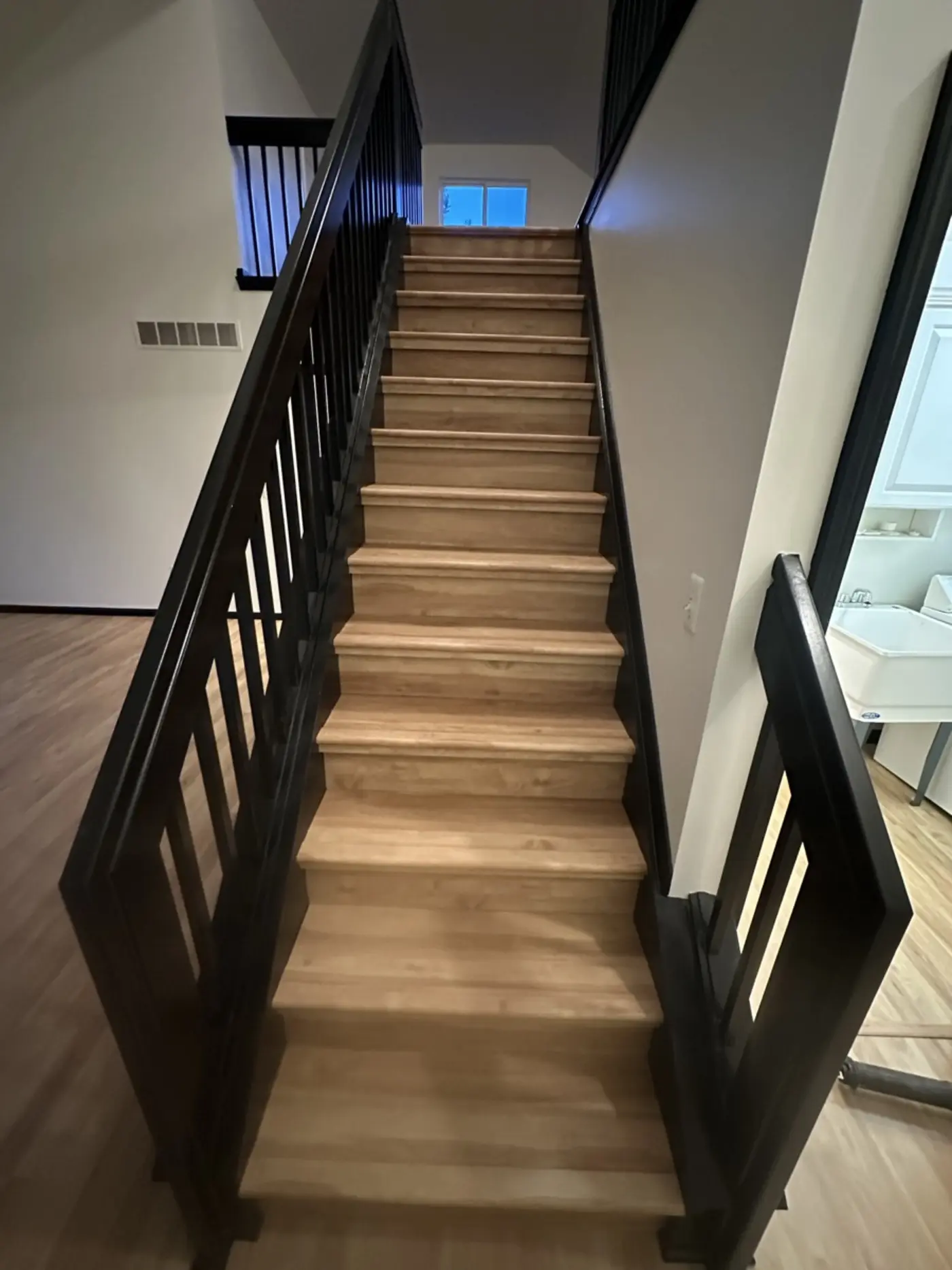 Finished open basement with wide luxury vinyl plank flooring